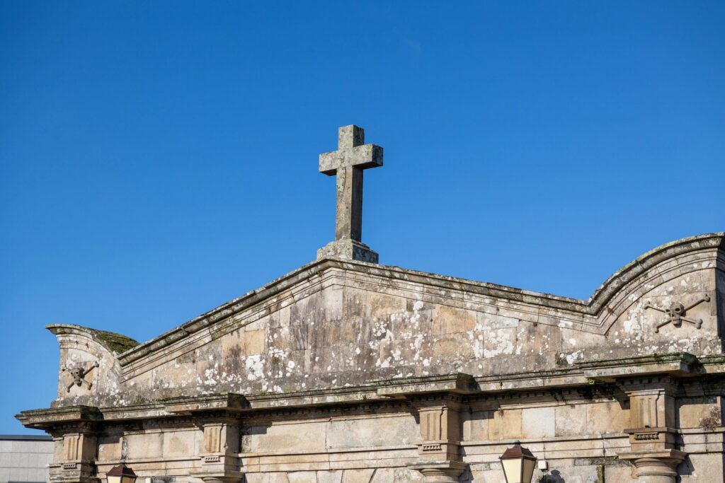 Stone cross and memento mori on church pediment